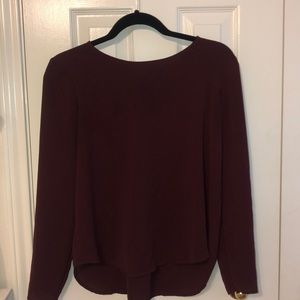 maroon top with cross up in the back